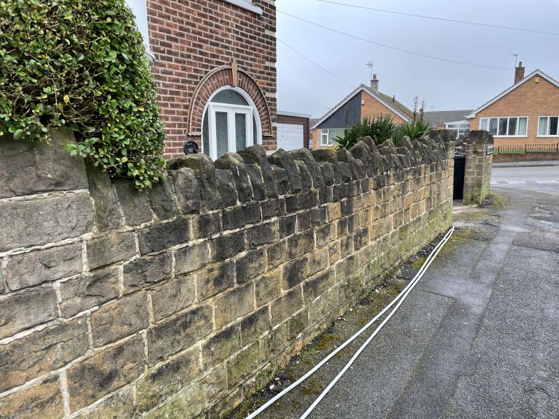 Stone wall in Langley mill&comma;Derbyshire before being cleaned : Swipe To View More Images